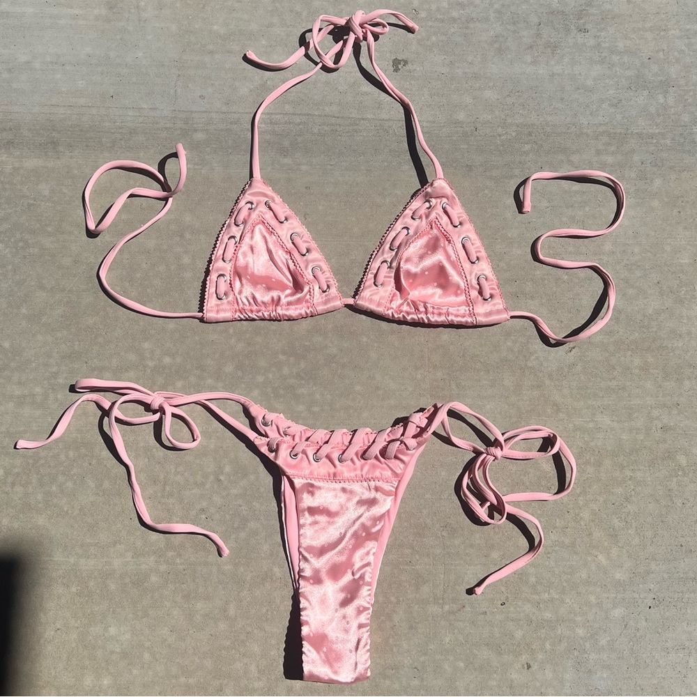 with jean juni bikini in baby pink w/ polka dots pattern and grommet detailing